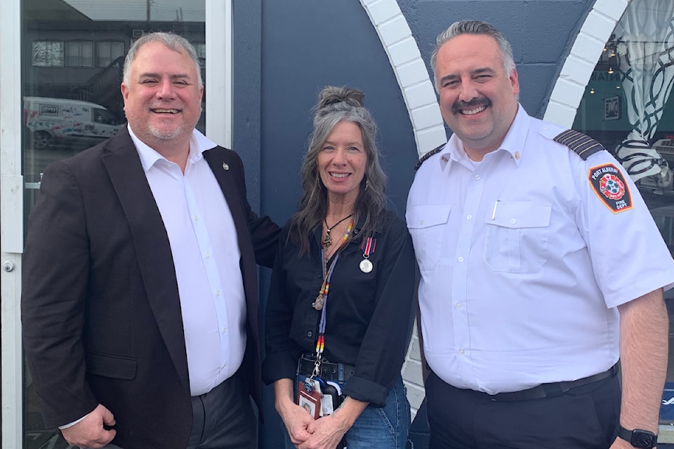 Courtenay-Alberni MP Gord Johns, left, and Port Alberni Fire Dept. Chief Mike Owens nominated Daphne Hollins for a King Charles III Coronation medal. 