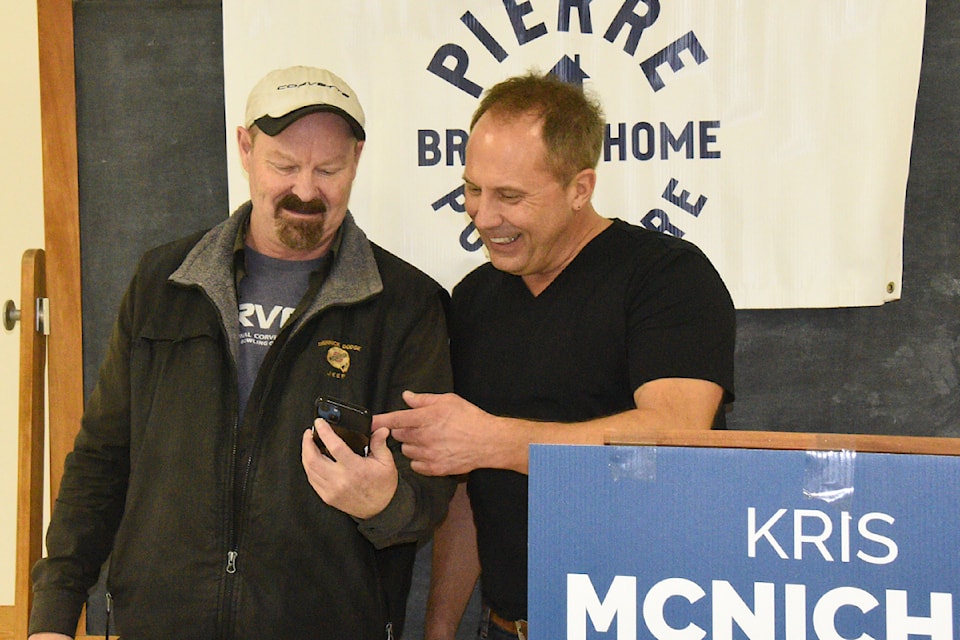 Al Lemoignan of Tofino, left, shows Courtenay-Alberni Conservative candidate Kris McNichol a photo Lemoignan took with federal Conservative Party leader Pierre Poilievre when he met him in person. 