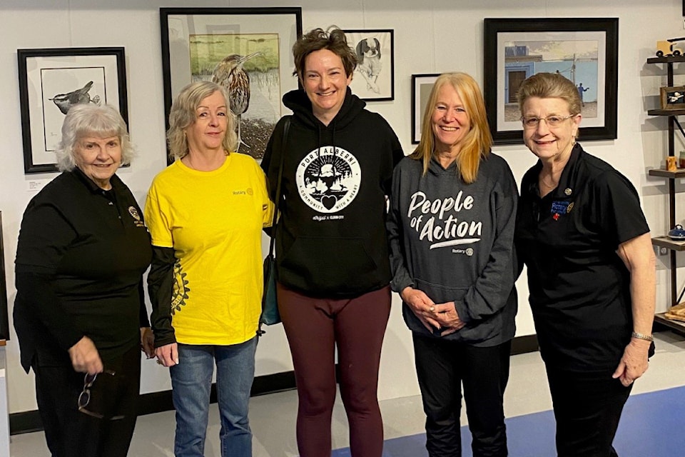 Members of the Arrowsmith Rotary Club congratulate Kama Money, centre, for winning the Iconic Alberni art exhibit people's choice award for her watercolour painting of the MV Frances Barkley. Money accepted her $500 prize on Tuesday, March 4, 2025 at the Grove Gallery at Harbour Quay. 