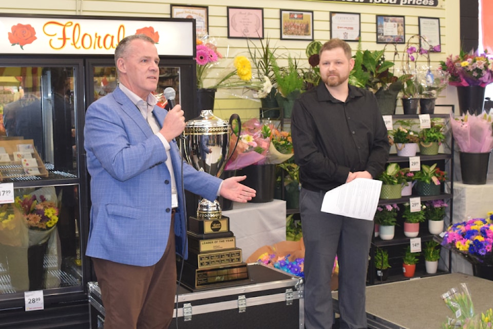 Jamie Nelson, the president of Pattison Food Group, presents the award for Small Format Store Leader of the Year to Brook Weightman of Buy-Low Foods in Port Alberni.
