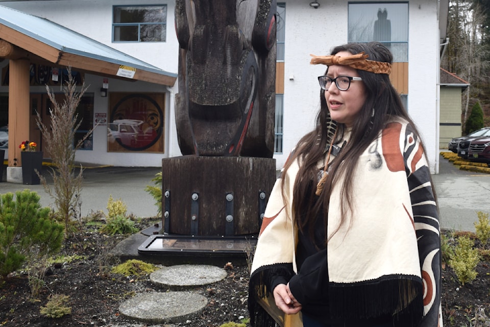 Evelyn Thompson-George speaks to the media outside of the Nuu-chah-nulth Tribal Council office, where a totem pole dedicated to the late Art Thompson.