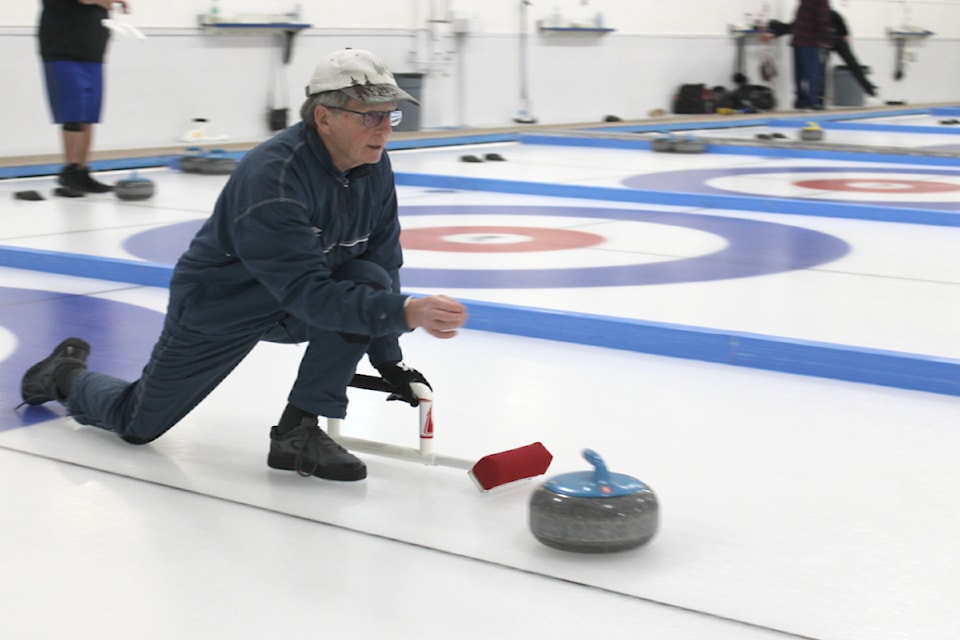 Randy Taylor releases his rock and checks out the direction that it is headed during a curling game in the Aurora Roofing Mixed Bonspiel at the Alberni Valley Curling Club, Saturday, March 15, 2025. 