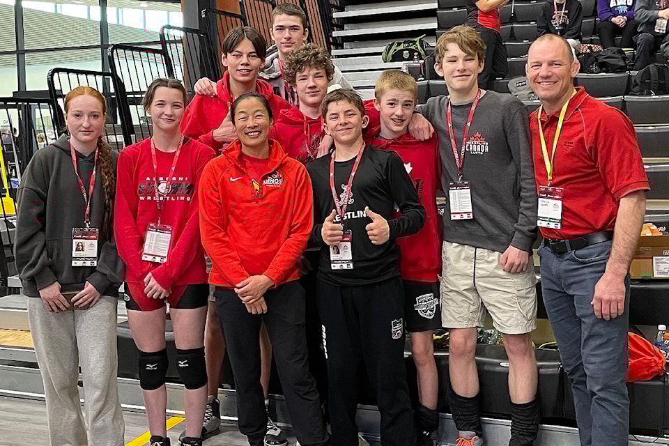 Alberni Valley wrestlers surround 2008 Olympic Gold Medallist Carol Huynh, third from left, who was inducted into Wrestling Canada's Hall of Fame at the Canadian National Championships in April 2025. Huynh has been a guest coach in Port Alberni in the past. (SUBMITTED PHOTO/ Alberni Valley News)