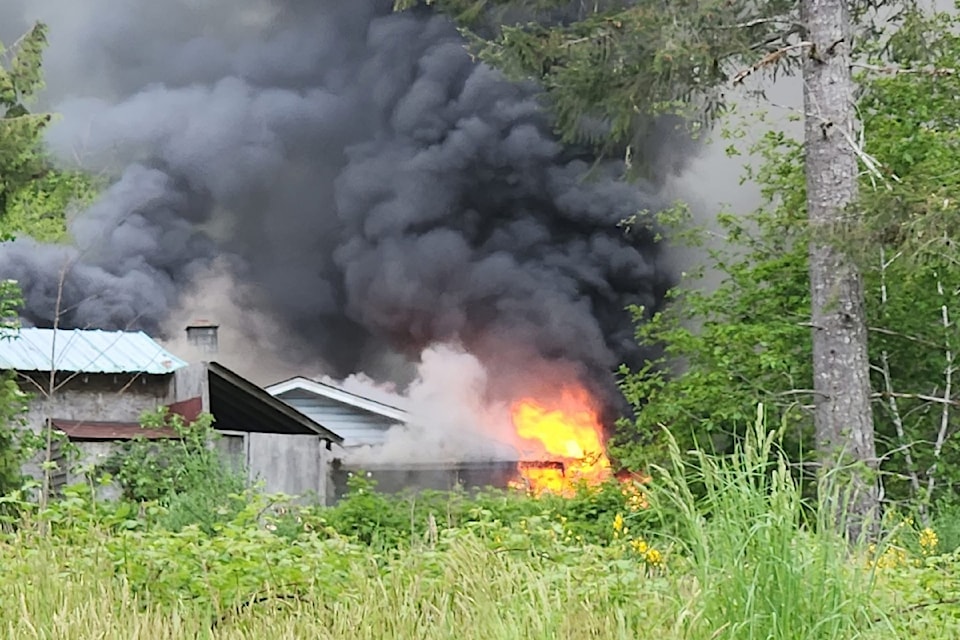 A house on Wattys Road in Tseshaht First Nation territory burns on Wednesday, May 14, 2025. A neighbour said all residents got out of the house safely, although two cats were unaccounted for. (C. ANNE ROBINSON/ Alberni Valley News)