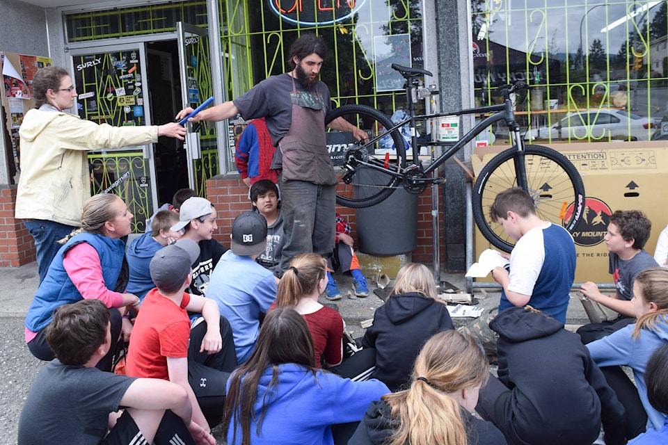 Students from Wood Elementary School watched a bike being built at Ozzie’s Cycle as part of the new cycling pilot project for the school. Elena Rardon photo