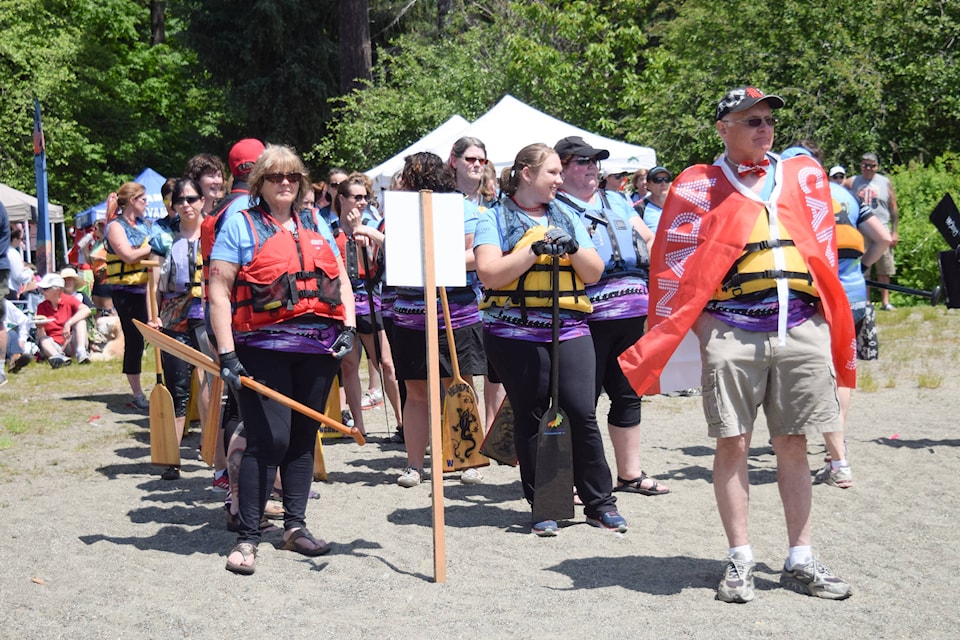 The Sproat Ness Dragons stand on deck during the Dragon Boat Regatta at Sproat Lake on Sunday, June 11. ELENA RARDON PHOTO.