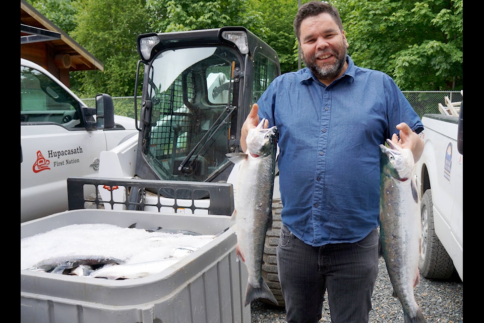 Steve Tatoosh, Hupacasath chief councillor, holds two of the approximately 1,400 sockeye salmon caught by a DFO test boat that were distributed to the nation’s members. KARLY BLATS PHOTO