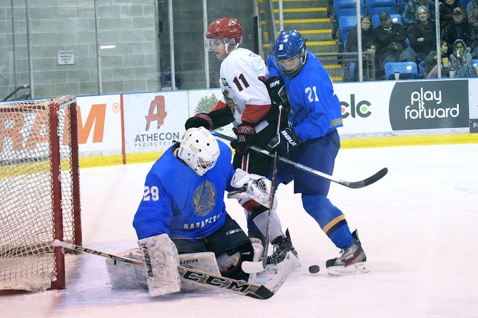 Bulldogs forward Dawson Tritt battles at the front of the Kazakhstan net in the second period of a game on Wednesday, Dec. 19. Tritt had one goal on Wednesday. ELENA RARDON PHOTO