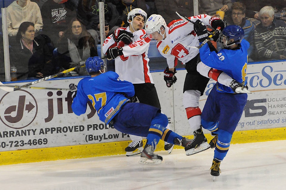 A pair of Swiss players, centre, collide with a pair of Kazakhstan players deep in Team Switzerland’s territory during the second period of a World Junior Hockey Championship pre-tournament game in Port Alberni on Dec. 21. SUSAN QUINN/ALBERNI VALLEY NEWS