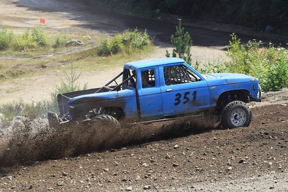 A truck kicks up some mud while taking a corner during the Wheel to Wheel race on Sunday. ELENA RARDON PHOTO