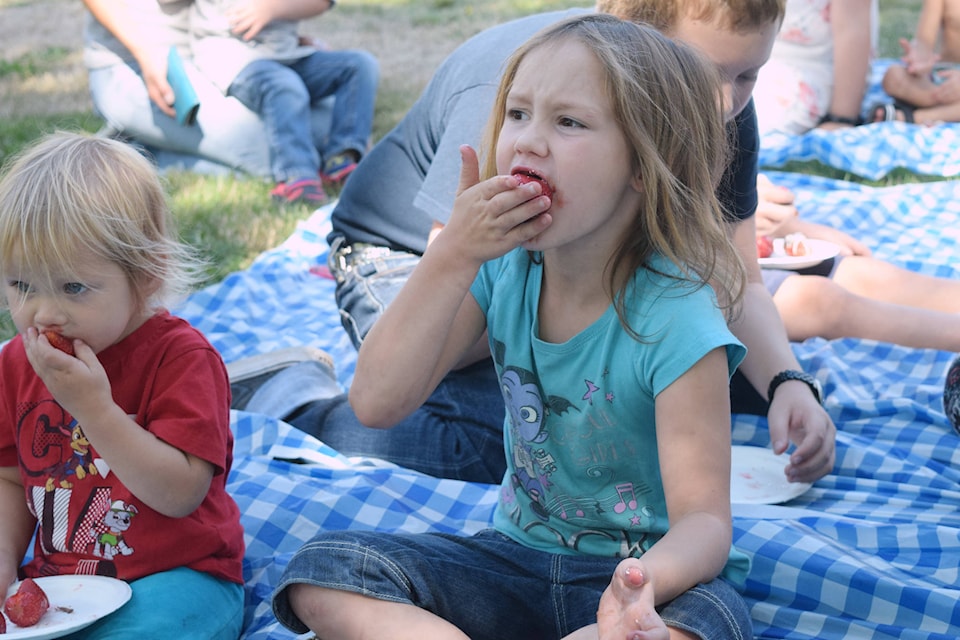 Isabelle Carpenter (and younger sister Sarah) competes in the chocolate-covered strawberry eating contest at Bearfoot in the Park. ELENA RARDON PHOTO