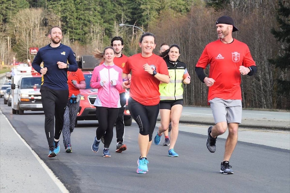 Port Alberni RCMP Cst. Maria Marciano leads the Wounded Warriors runners into Port Alberni on Thursday afternoon. (ELENA RARDON / ALBERNI VALLEY NEWS)