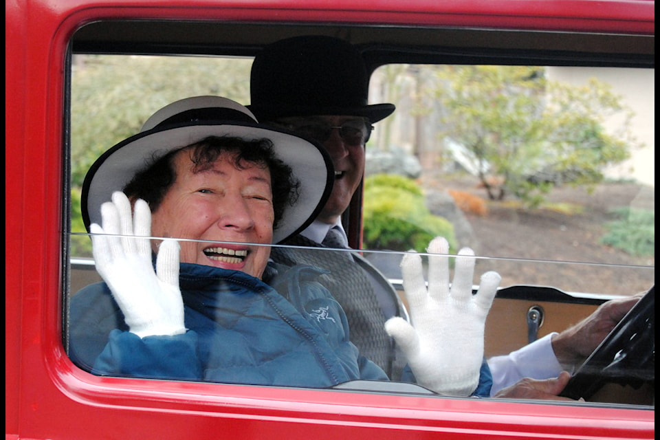 Pauline Gray waves to her neighbours while on a special ride in a 1930 Model T on her 90th birthday. (Michael Briones photo)