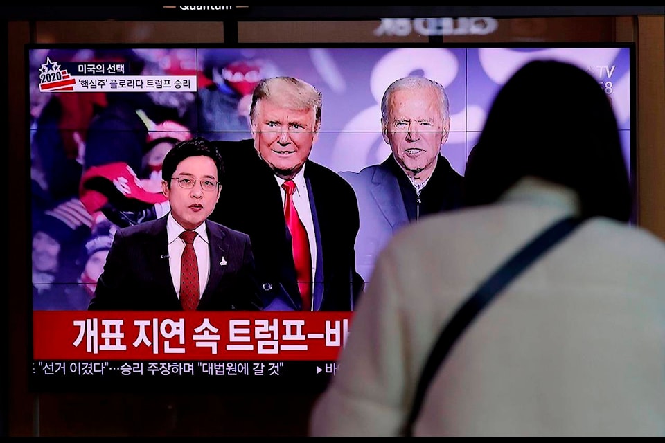 A TV screen shows images of U.S. President Donald Trump and Democratic presidential candidate former Vice President Joe Biden during a news program, at the Seoul Railway Station in Seoul, South Korea, Wednesday, Nov. 4, 2020. (AP Photo/Lee Jin-man)