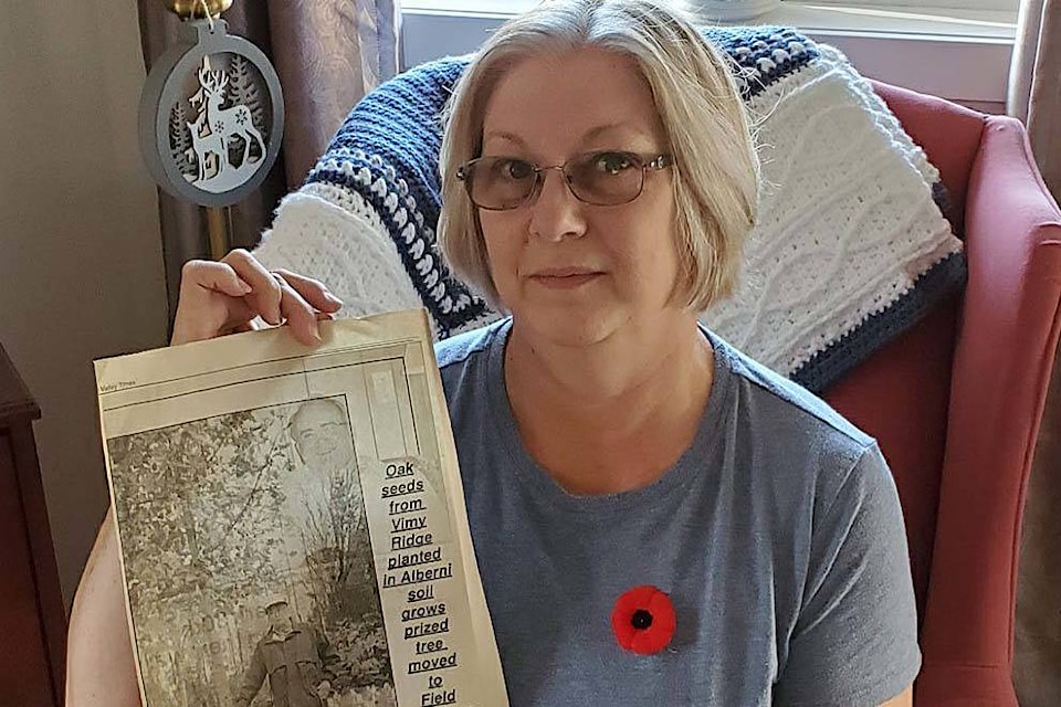 Susan McCarthy, the youngest daughter of the late Robert McVie, holds a newspaper clipping of her father helping plant the Vimy oak tree in Port Alberni’s Field of Honour at Greenwood Cemetery. (PHOTO COURTESY TRICIA ABBOTT)
