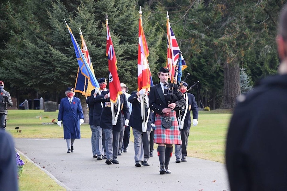 Piper George Batt of the West Coast Highlanders Pipe and Drum Band leads the Royal Canadian Legion Branch 293 colour party to the Field of Honour at Greenwood Cemetery in Port Alberni. (ELENA RARDON / ALBERNI VALLEY NEWS)