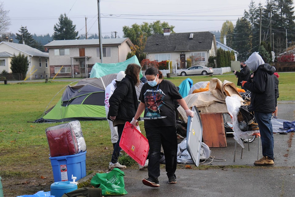 Island Health workers, volunteers and occupants on Nov. 13, 2020 clean up a ‘tent city’ in front of Our Home on Eighth shelter that has been there since Oct. 23. (SUSAN QUINN/ Alberni Valley News)