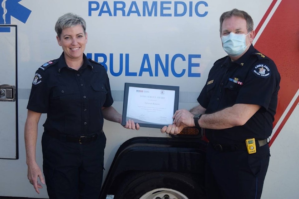Deb Roberts receives her long service award from area director Lance Stephenson for 20 years of service with BC Emergency Health Services. (ELENA RARDON / ALBERNI VALLEY NEWS)