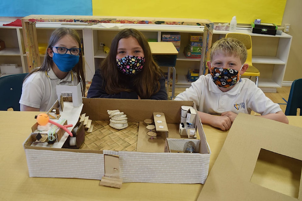 TEACHING TINY HOMES Rachel Salmon, Sophie Kennedy and Matthew Andersen of John Paul II Catholic School show off their tiny home, constructed entirely from recycled materials. Students at John Paul II have been participating in a “Tiny Home Challenge” to design and develop a sustainable home. Read more about this project on page A5. (ELENA RARDON / ALBERNI VALLEY NEWS)