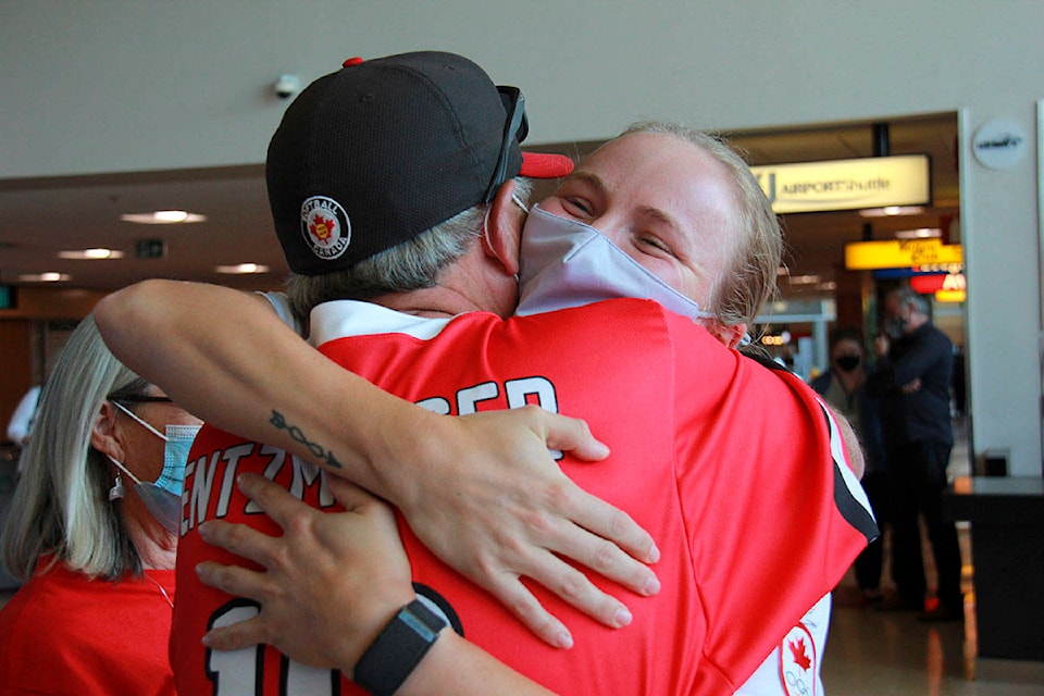 Emma Entzminger hugs her dad John Entzminger as he welcomes her back from her Olympic win. (Jane Skrypnek/News Staff)