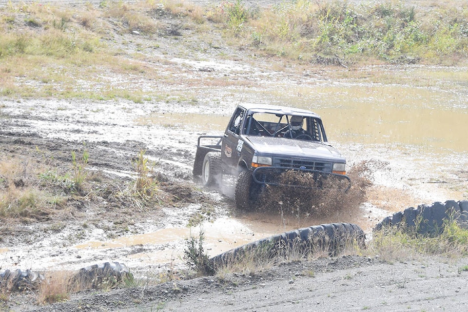 A vehicle plows through a mud puddle during off-roading action at Alberni Motorsports Park on Saturday, Sept. 18. (ELENA RARDON / ALBERNI VALLEY NEWS)