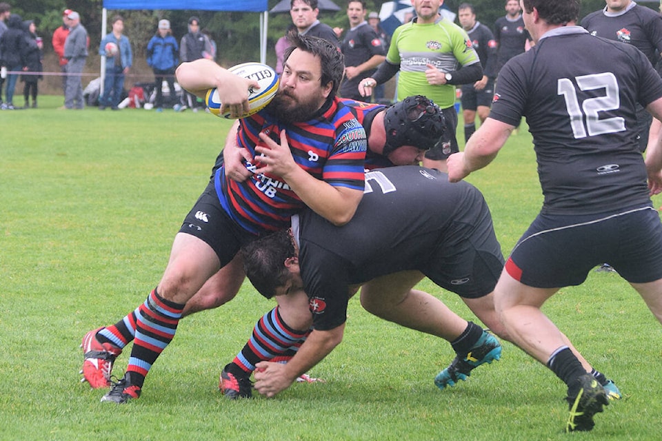 Port Alberni Black Sheep players team up to take down a Castaway Wanderer during rugby action on Oct. 23. (ELENA RARDON / ALBERNI VALLEY NEWS)