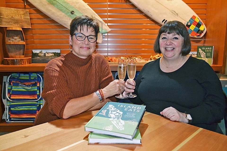 Island Eats co-authors Dawn Postnikoff and Joanne Sasvari toast to the release of their new cookbook during a launch party at Long Beach Lodge Surf Club on Oct. 21. (Nora O’Malley photo)