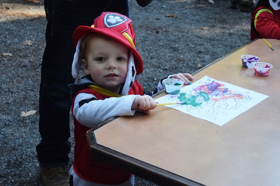 William Simmons, dressed as Marshall from Paw Patrol, paints a picture during Halloween activities at McLean Mill. (ELENA RARDON / ALBERNI VALLEY NEWS)