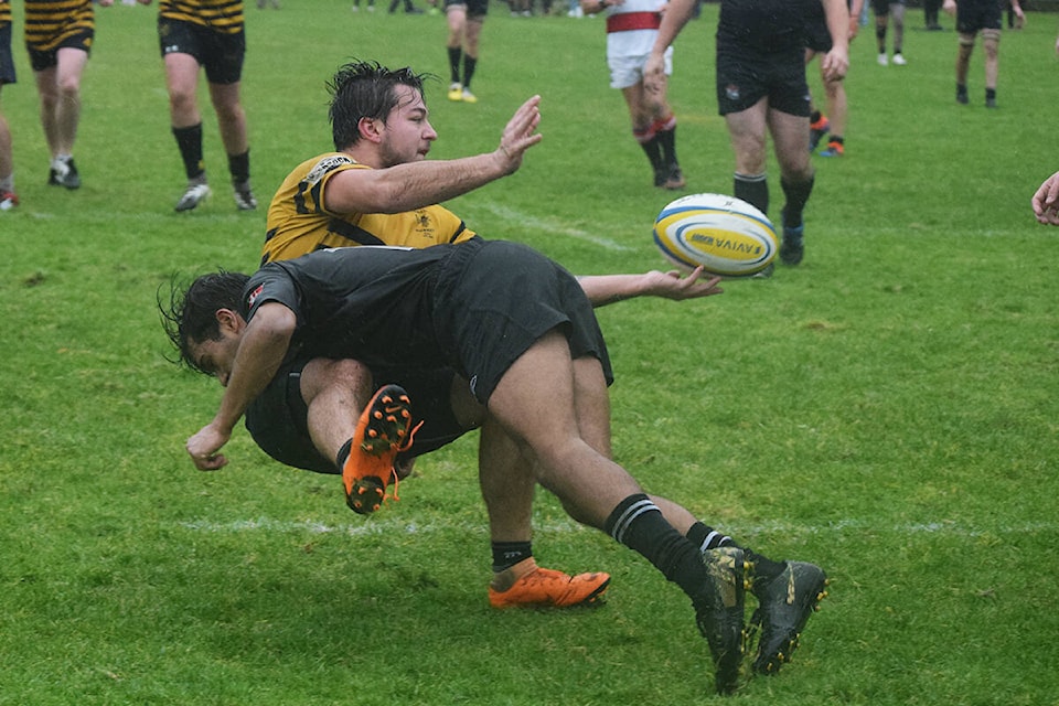 A player from the Nanaimo Hornets attempts to pass the ball as he is taken down by Kyle Parkar of the Port Alberni Black Sheep. (ELENA RARDON / ALBERNI VALLEY NEWS)