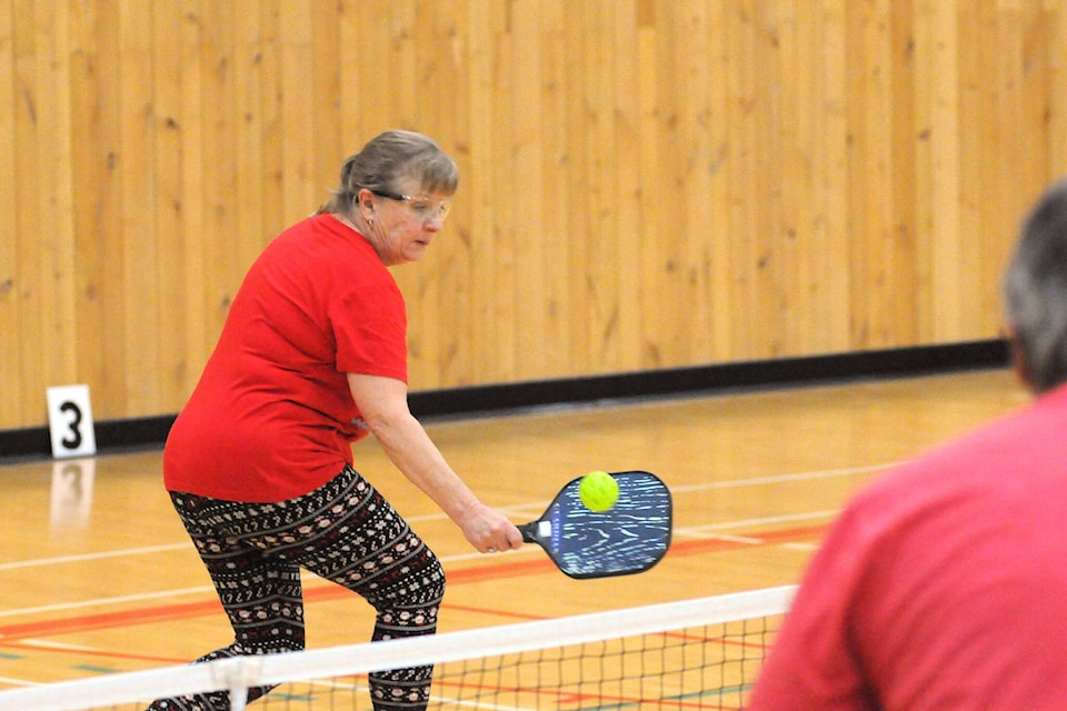 Donna Michaud returns a volley from Bryce Barr during a fun pickle ball tournament with the PA Picklers Association, Dec. 14, 2021 at the Alberni Athletic Hall. (SUSAN QUINN/ Alberni Valley News)
