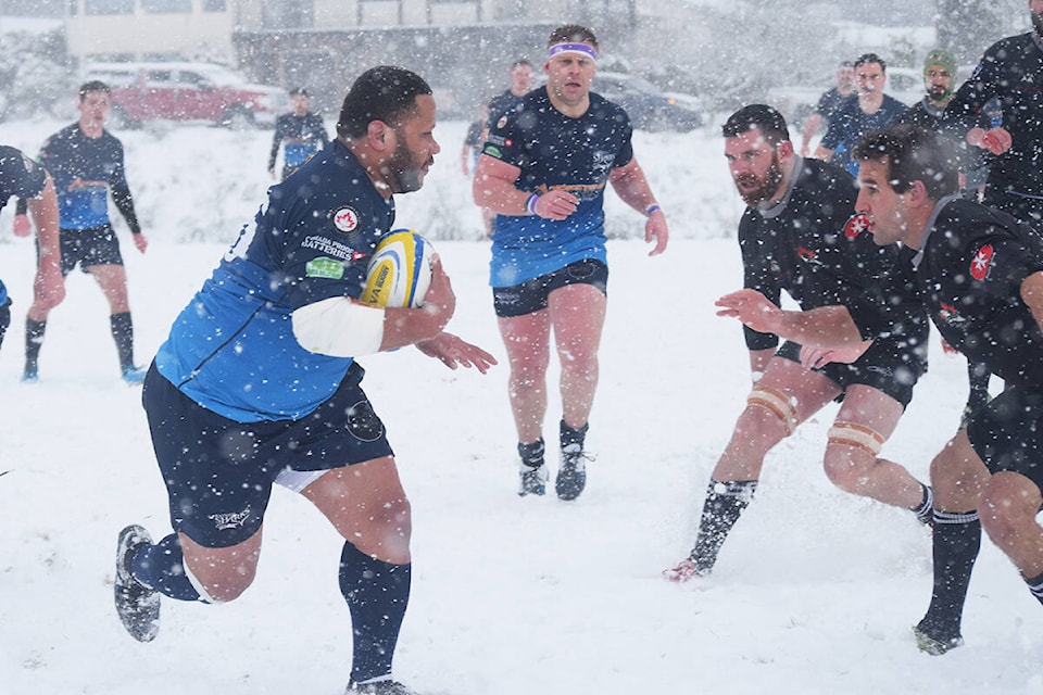 A Bayside player attempts to get past the Black Sheep during snowy BC Rugby action on Feb. 26, 2022. (ELENA RARDON / ALBERNI VALLEY NEWS)