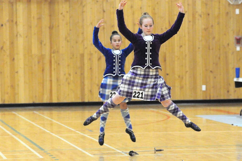 Paisley Barolet of Port McNeill, front, and Allison McBride of Nanaimo perform in the Premier Under-16 sword event at the 42nd Port Alberni Highland competition Saturday, April 9 at the Alberni Athletic Hall. (SUSAN QUINN/ Alberni Valley News)