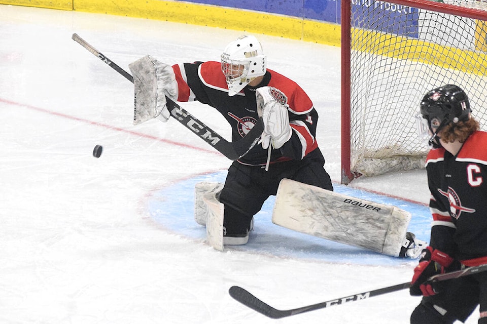 Port Alberni Bombers goaltender Callum Tung makes a blocker save during a game against the Campbell River Storm at the Alberni Valley Multiplex on Jan. 26, 2022. (ELENA RARDON / ALBERNI VALLEY NEWS)