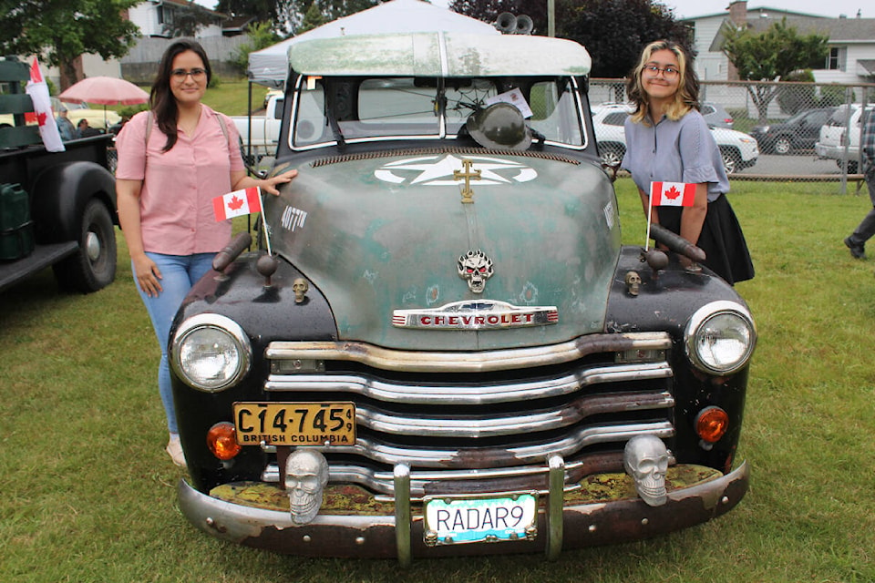 Corina, left, and Naomi Sanmiya pose with Kory Scaris Brick’s 1947 Chevy truck rat rod at the Golden Oldies Car Show at Gyro Williamson Park on July 3, 2022. (SONJA DRINKWATER/ Special to the AV News)