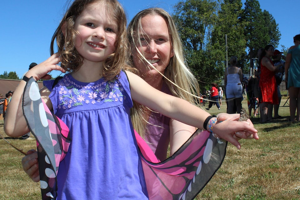 Aria Hurni, age three, had a very tame butterfly that was not in a hurry to leave. (SONJA DRINKWATER / ALBERNI VALLEY NEWS)