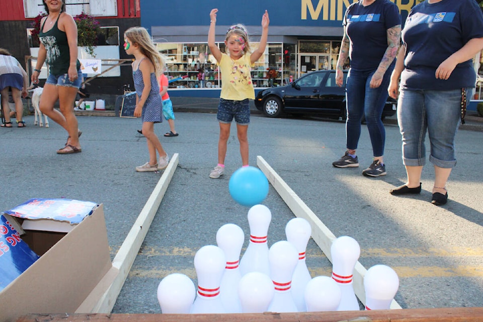 Anneli Orser, age seven, takes part in the bowling game on Third Avenue. (SONJA DRINKWATER / ALBERNI VALLEY NEWS)