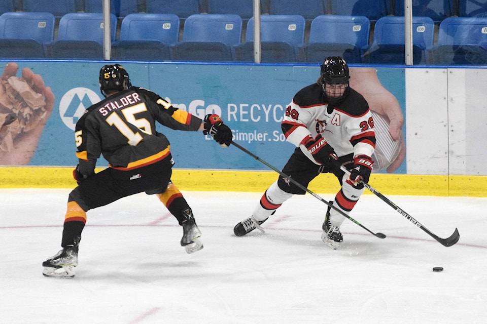 Port Alberni Bombers forward Sam Davidson handles the puck around Victoria defenceman Ken Stalder during a game at the Alberni Valley Multiplex on Saturday, Sept. 17. (ELENA RARDON / ALBERNI VALLEY NEWS)