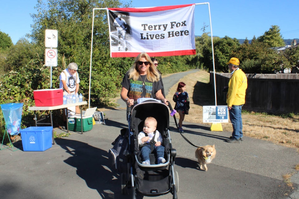 Diane Goddard ran in the Terry Fox Run on Sunday, Sept. 18 for the late Ken and Mary Goddard and Avis and Rudy Johanson. She finished first in the 2K run. She is seen here with her grandson Liam Goddard, age 11 months, and her dog Sidney. (SONJA DRINKWATER / ALBERNI VALLEY NEWS)