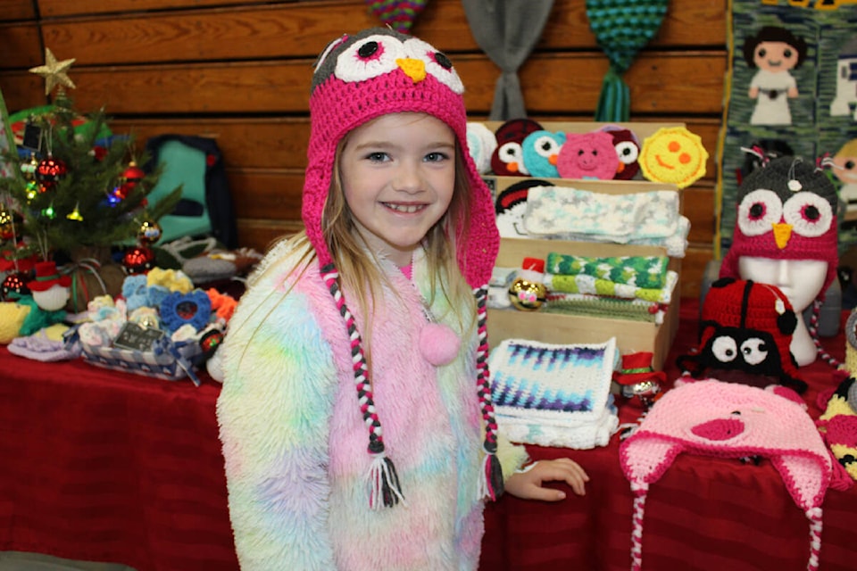 Abigail Von Brendel picked out her favourite hat from this booth. The hats will be available at the Kinsmen Centre on Dec. 2. (SONJA DRINKWATER / ALBERNI VALLEY NEWS)