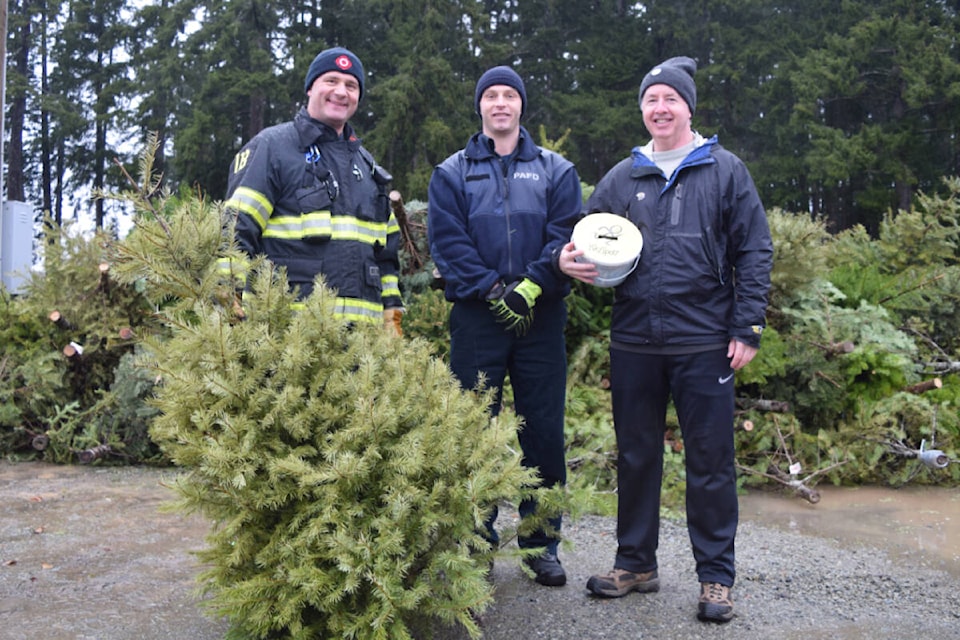 Members of the Port Alberni Fire Department and volunteers with KidSport collected donations and old Christmas trees on Saturday, Jan. 7 behind the Echo Centre. The event raised funds for KidSport Port Alberni. (ELENA RARDON / Alberni Valley News)