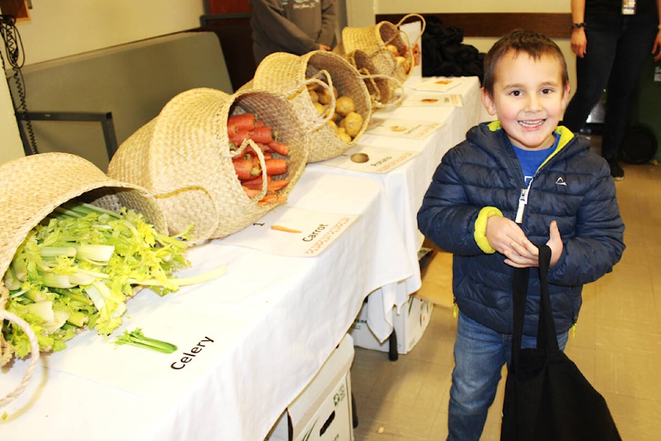 Jack Simmons, 5, has fun picking up ingredients to make soup from a recipe provided at the Family Literacy Event on Saturday, Feb. 4, 2023 at Echo Centre. (SONJA DRINKWATER/ Special to the AV News)
