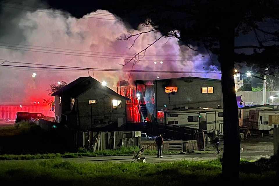 A fire burns through a top floor unit of Wintergreen Apartments around 11:30 p.m. on Thursday, May 18 2023. Multiple fire departments battled the blaze. Trailers in the lot beside the apartment were evacuated by emergency personnel. (SUSAN QUINN/ Alberni Valley News)