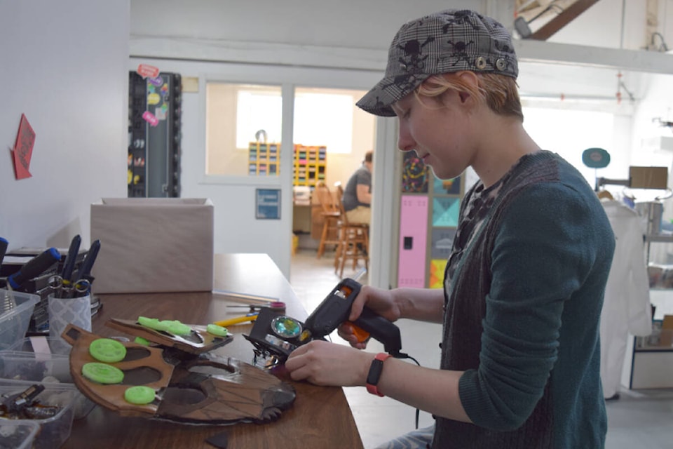 Emma Wall works on a handmade cosplay mask from the show Trigun Stampede at the Alberni Valley Makerspace. (ELENA RARDON / Alberni Valley News)