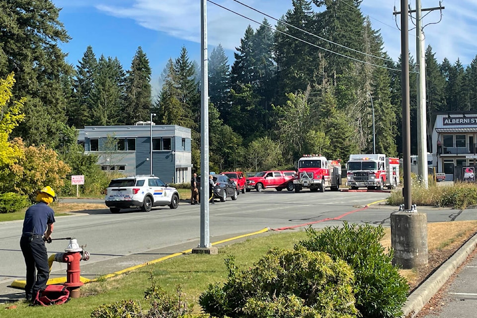 Firefighters stage at the end of Cherry Creek Road by Alberni Storage in order to knock down a fire in the bush behind the building. The call came in just after 5 p.m. on Tuesday, July 18, 2023. (TONY SHUMUK PHOTO)