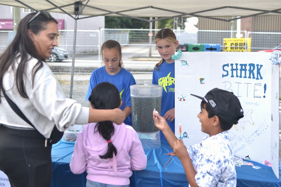 Friends Aslynn, 12, and Abby, 13, sold blue raspberry lemonade on Sunday, Aug. 25. (Kyler Emerson/Aldergrove Star)