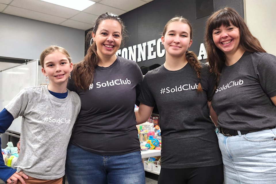 Emma Stewart (centre left) and her team behind the first free holiday shopping experience in Aldergrove in early December. (Kyler Emerson/Aldergrove Star)