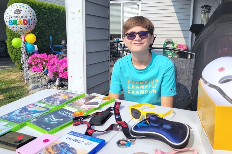 Nathan, 13, participated in the Aldergrove annual garage sale on Saturday, July 27, for the first time. (Kyler Emerson/Aldergrove Star)