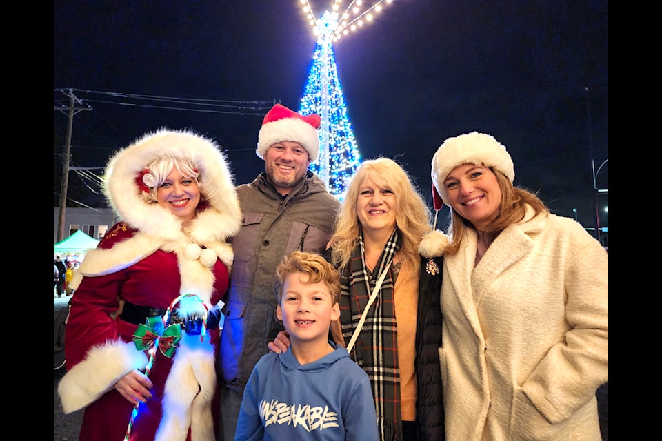 Mrs. Claus posed for a photo with Shortreed Community Elementary principal, Chris Wejr, and his family at the treelighting festivities on Sunday, Nov. 24. (Kyler Emerson/Aldergrove Star)