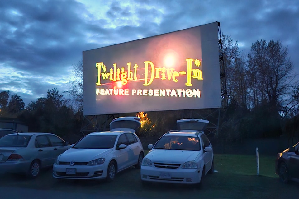 Authentic street scene of Twilight Drive-in Theatre capturing a retro movie screen at dusk