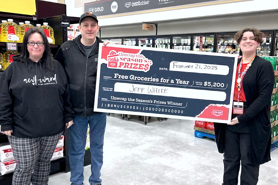 Jeff White (left) was presented a cheque for free groceries for a year on Feb. 21 at the Cloverdale Co-op Essentials store. (Special to The Star)